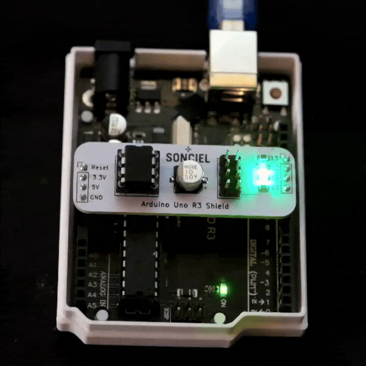 Arduino Uno R3 with programming shield and ATtiny 85 chip fitted. Gif of flashing red and green programming LEDs